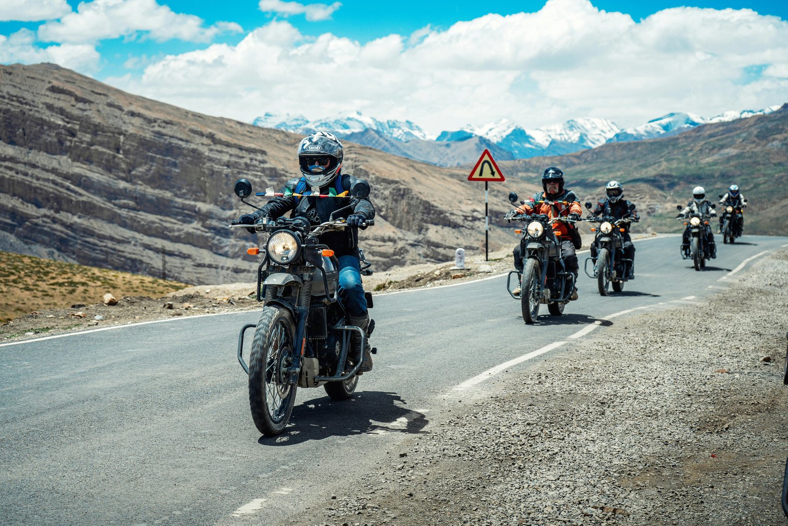 Riders on an open mountain road